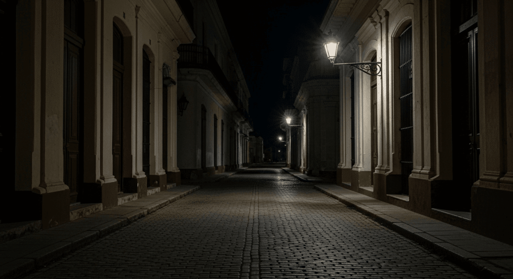 A dimly lit and empty cobblestone alley at night in Havana, Cuba, illustrating an area where travelers should be cautious for safety.